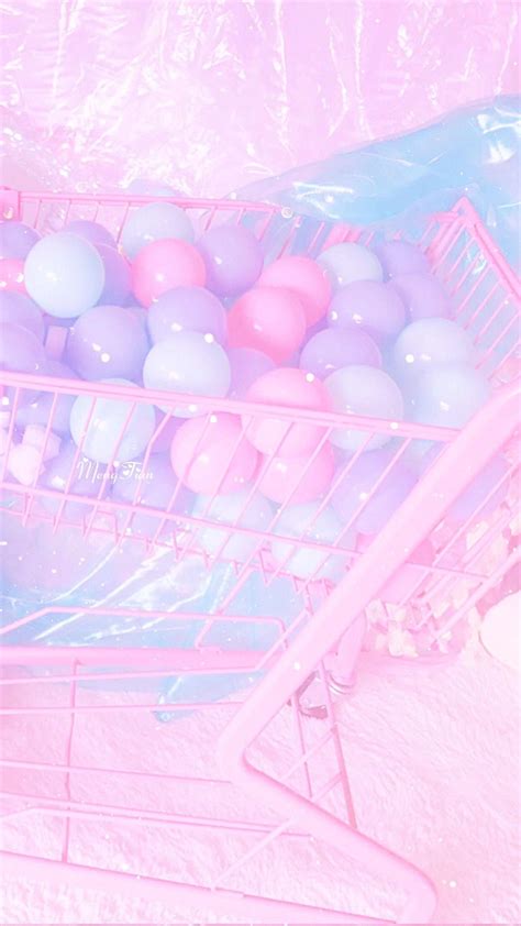A Pink Shopping Cart Filled With Lots Of Balloons