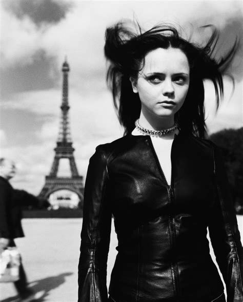 Black And White Photograph Of Woman In Leather Outfit With Eiffel Tower