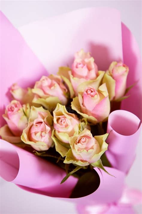 Delicate Bouquet Of Fresh Pink Roses On A Textured White Wood
