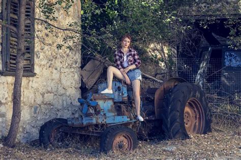 Young Beautiful Pin Up Girl Sitting On A Retro Tractor Close Up Stock