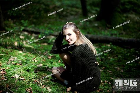 Girl Squatting On The Forest Floor Portrait Stock Photo Picture And