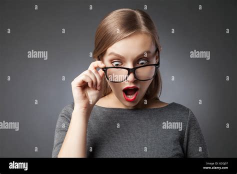 Wide Eyed Woman In Glasses Looking Down In Amazement Stock Photo Alamy