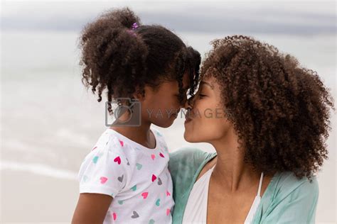 Mother And Daughter Rubbing Noses On A Sunny Day By Wavebreakmedia