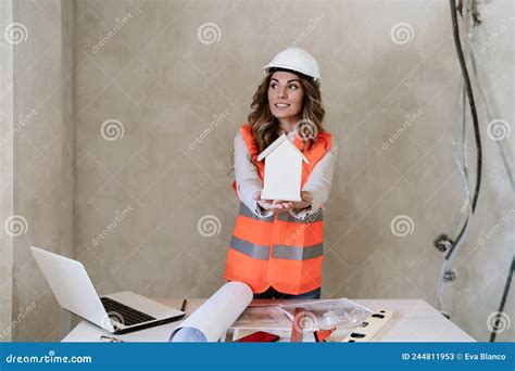 professional confident architect woman in construction site holding house model home renovation