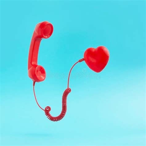 Retro Red Telephone Handset Connected To Red Heart On Pastel Blue