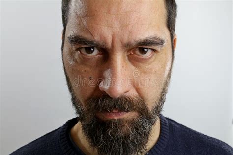 Handsome Bearded Man With Serious Face Looking At The Camera Stock