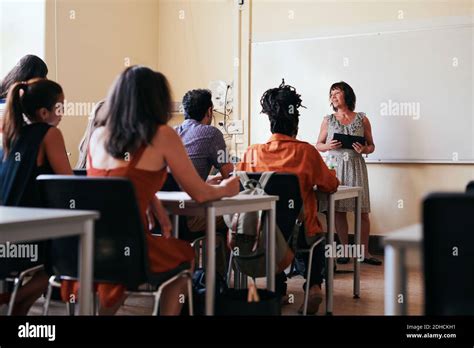 Teacher Explaining To Students In Classroom Stock Photo Alamy