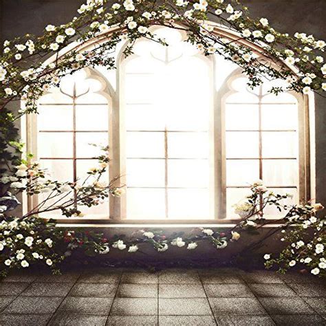 An Open Window With White Flowers On The Outside And Light Coming In