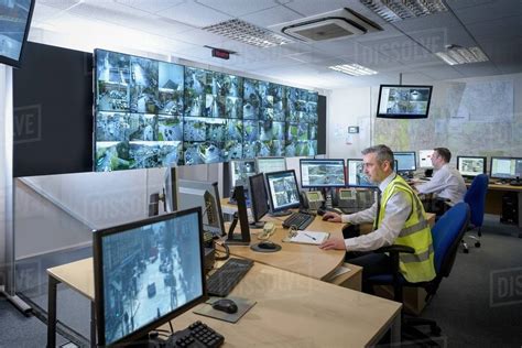 Security Guards In Security Control Room With Video Wall Stock Photo