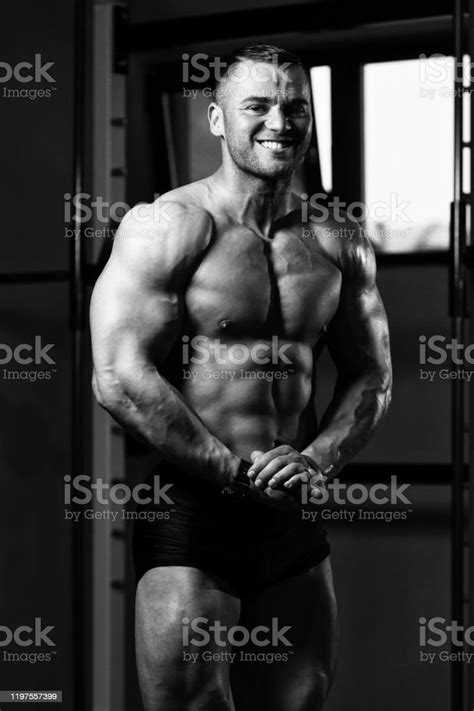 Healthy Young Man Flexing Muscles Stock Photo Download Image Now