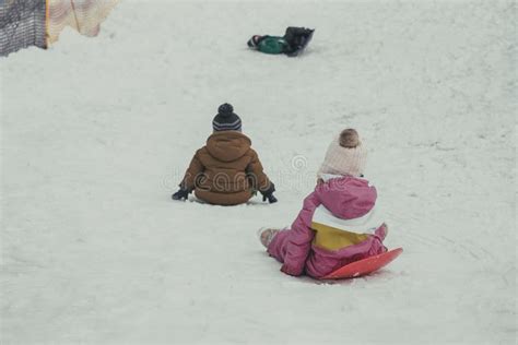 Winter Resort Children Slide Down The Hill Snow Stock Image Image