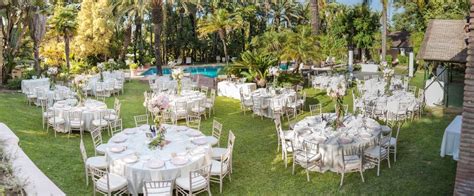 Tables And Chairs Are Set Up In The Yard For An Outdoor Wedding