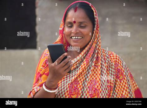 Indian Rural Woman Holding Mobile Phone Stock Photo Alamy