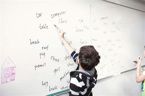 Schoolboy Writing Spellings — Schoolboys Classroom Stock Photo