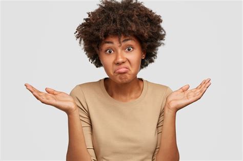 Free Photo Clueless Black Woman With Puzzled Expression Has Doubtful