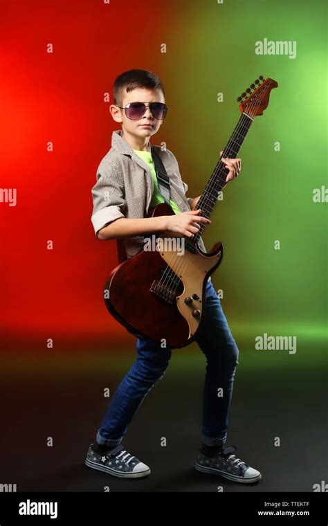 Little Boy Playing Guitar On A Bright Background Stock Photo Alamy