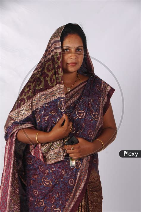 Image Of An Indian Woman In Casual Saree Or Sari And Veil Over Her Head