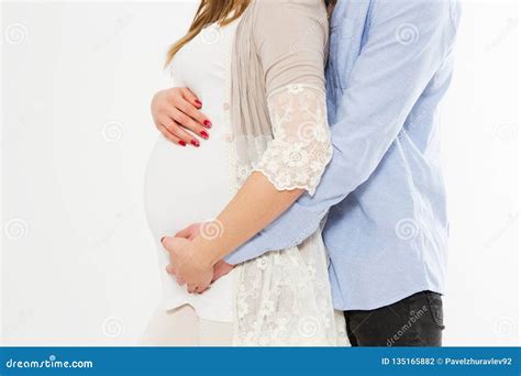 Beautiful Pregnant Woman And Her Handsome Husband Hugging The Tummycopy Spaceisolated On White