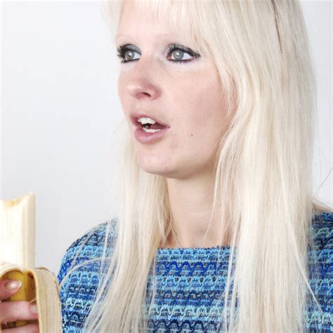 blonde woman eating a banana license download or print for £2 48 photos picfair