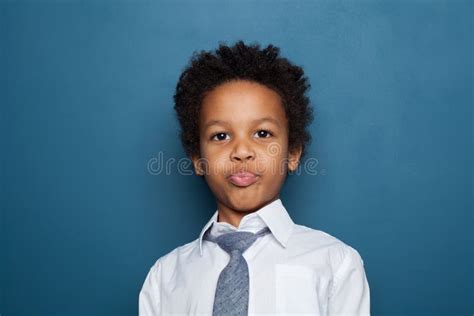 Portrait Of Little Funny Black Kid Boy On Blue Background Stock Image