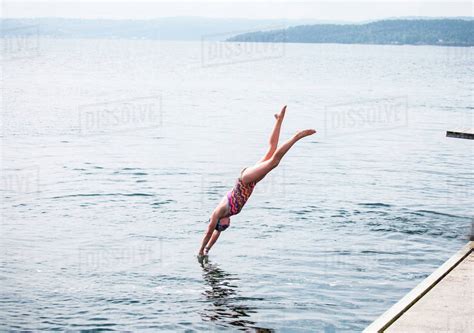 Caucasian Girl Diving Into Lake Stock Photo Dissolve