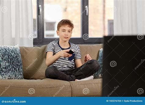 Boy With Remote Control Watching Tv At Home Stock Photo Image Of