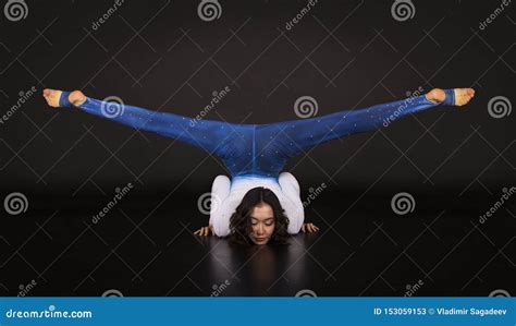 Girl Acrobat Gymnastics A Young Athlete In A Blue And White Suit Practicing Acrobatics