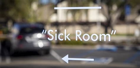 Sign Stating Sick Room On Glass In White Letters On Outside Window At