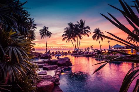 Stunning Sunset View With Palm Trees Reflecting In Swimming Pool In