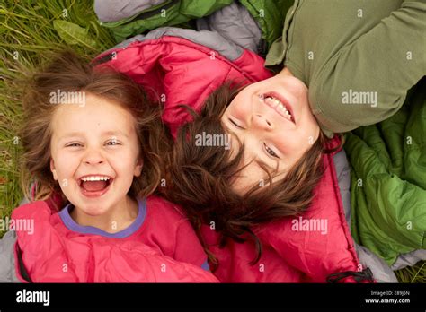Laughing Kids Laying On Sleeping Bags Stock Photo Alamy