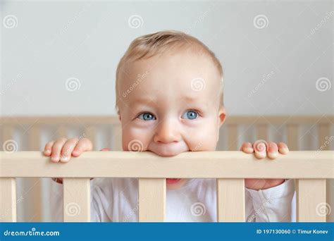 Blond Cute Little Baby Biting Wooden Bed Headboard Stock Photo Image