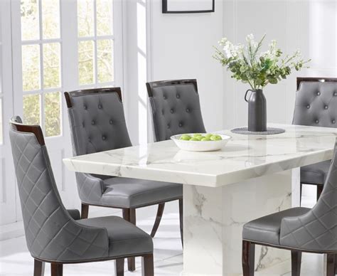 An open, swirl back design on the chairs will be the reason you want to update your dining furniture. Stylish white marble dining table with 6 grey chairs - Homegenies