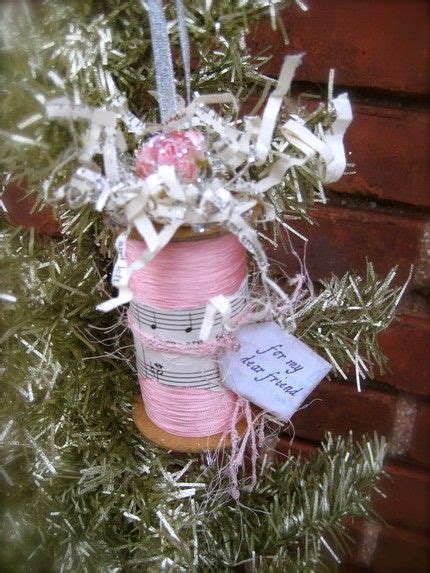 An Ornament Is Hanging From A Tree With Ribbon And Ribbons On Its Branches