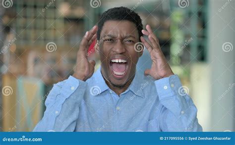 Portrait Of Angry Young African Man Shouting Screaming Stock Photo