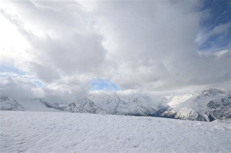 Snowy Mountain Peaks Large High Altitude Mountains With Blue Sky