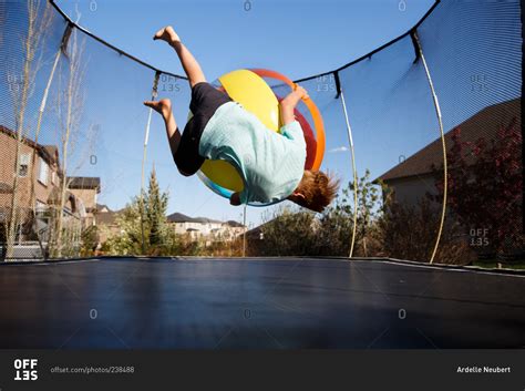 Boy Playing On A Trampoline With A Ball Stock Photo Offset