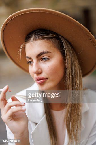 Young Woman Smoking Cigarette Outdoors High Res Stock Photo Getty Images