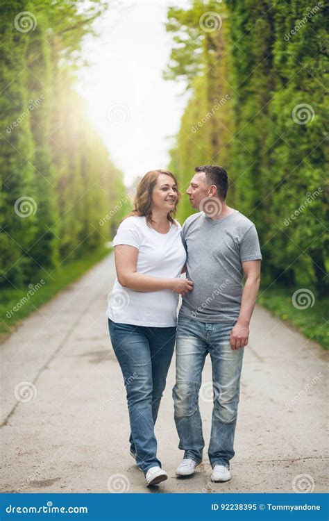 Happy Loving Couple On A Romantic Walk Outdoors In Park Stock Image