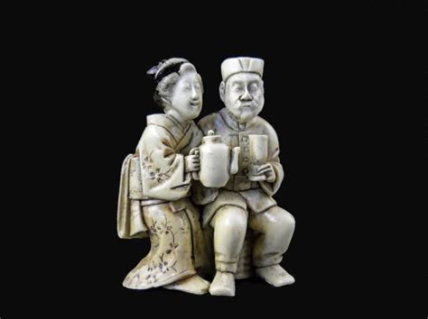 hand carved and signed by the artist on the bottom netsuke depicts a couple sitting together