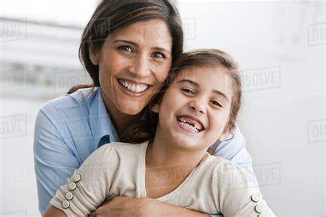 Smiling Mother And Daughter Hugging Stock Photo Dissolve
