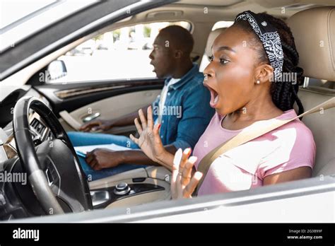 Shocked Black Lady Driving Car Yelling And Gesturing While Looking On