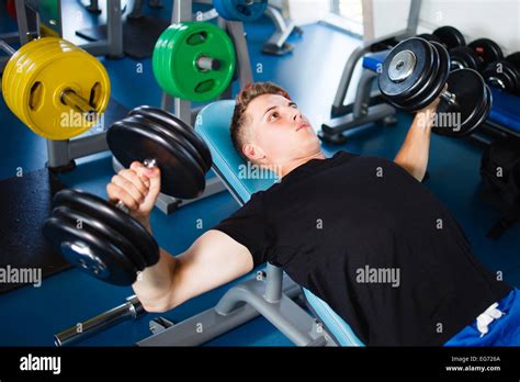 Exercising With Dumbbells At Gym Stock Photo Alamy