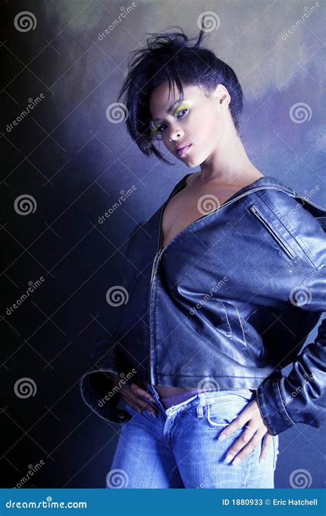 teenage african american girl wearing a leather jacket showing her underwear royalty free stock
