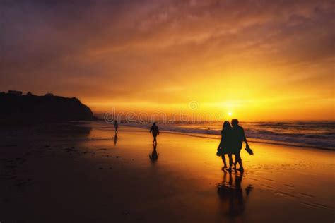 People Walking On Beach At Sunset Stock Photo Image Of Shore