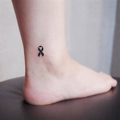Black Ribbon Tattoo On The Ankle