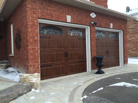 8x7 Clopay Walnut Finish Carriage Doors With Arched Wrought Iron Windows And Colonial Decorative