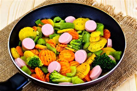 Steamed Vegetables Potatoes Carrots And Broccoli With Sausages Stock