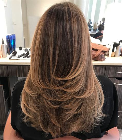 Feathering is a texturizing technique that shapes the ends of your tresses, while layering is a cut that creates variable lengths throughout your hair. Photo Gallery of Long Feather Cut Bangs Hairstyles With ...