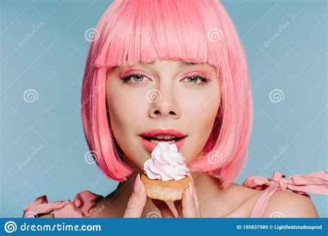 Beautiful Sensual Girl In Pink Wig Eating Cupcake With Buttercream