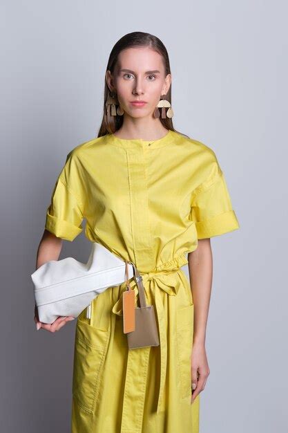 Premium Photo Cute Fashion Model In Yellow Dress With Handbag